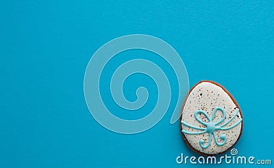 Easter ginger glazed cookies in the shape of an egg in a row. Easter holiday concept. Egg on a blue background with place for text Stock Photo